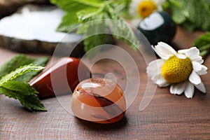 Beautiful gemstones and camomile flowers on table, closeup. Healing crystals