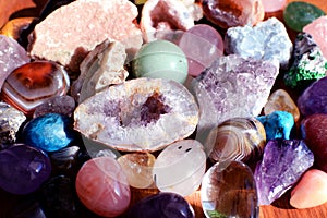 Beautiful gemstones,  geode amethyst and druses of natural purple mineral amethyst on a wooden background. Amethysts and rose