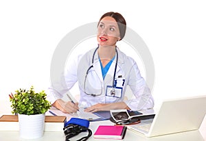 Beautiful general practitioner is working with joy. She is standing with a folder of documents in her hand