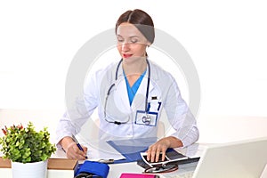 Beautiful general practitioner is working with joy. She is standing with a folder of documents in her hand