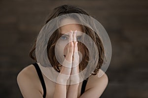 Beautiful and gentle girl posing with hands near face