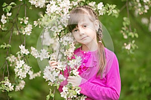 Beautiful gentle girl standing in a lush garden