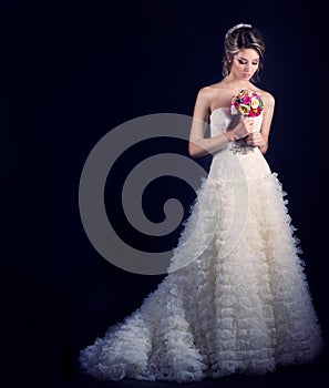 Beautiful gentle woman happy bride in a white wedding dress with a train cabin with a beautiful wedding hairstyle with white