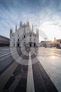 Beautiful geometric picture of Piazza Duomo of Milan at sunrise and sun star