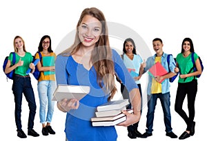 Beautiful german female student with books and group of students