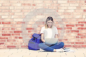 Beautiful german female student learning at computer