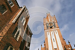 beautiful German Gothic architecture. Red brick tower on blue sky background