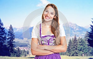 Beautiful german woman in bavarian dirndl with rural landscape