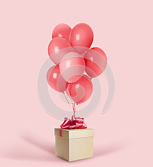 Beautiful gift box and bunch of red balloons on pink background