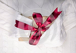 Beautiful gift box with red bow knot on white sweater