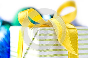 Beautiful gift box with yellow ribbon over white