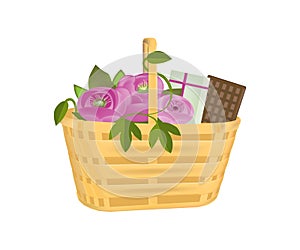 Beautiful gift wicker basket with flowers, gifts and chocolate.