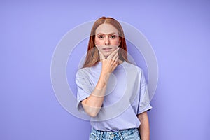 beautiful ginger girl with hand on her chin looking at camera