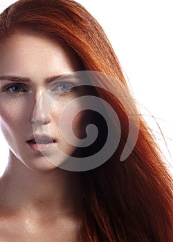 Beautiful ginger young woman with flying hair and naturel makeup. Beauty portrait of model with straight red hair