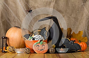 Beautiful gingerbread for Halloween and fresh pumpkin close-up on the table