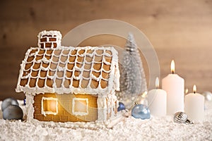 Beautiful gingerbread house and Christmas decor on snow