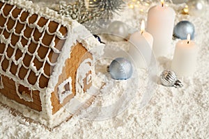 Beautiful gingerbread house and Christmas decor on snow