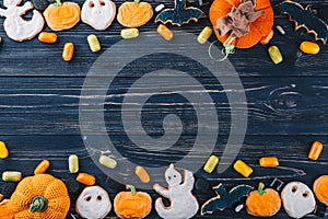 Beautiful gingerbread and sweets for Halloween and pumpkin on the table. Trick or Treat horizontal view from above