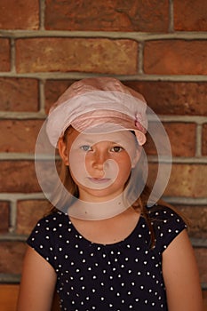 Beautiful girl against the background of a brick wall close-up