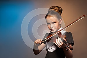 Beautiful girl alone playing on the violin