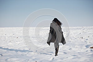 Beautiful girl alone in winter field