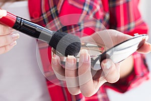 Beautiful girl applying make up.