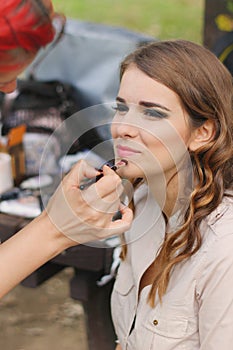 Beautiful girl applying makeup