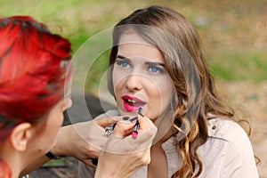 Beautiful girl applying makeup