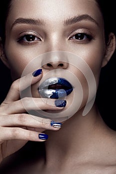 Beautiful girl with art make-up, dark glitter lips design and manicured nails. beauty face.