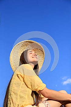 Beautiful girl in background of the blue sky