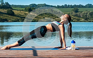 Beautiful girl on the background of nature is engaged in yoga. Reverse Plank Pose or Purvottanasana