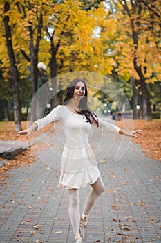 Beautiful girl ballerina dancing outdoor