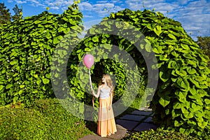 Beautiful girl with balloon have a fun in the park.