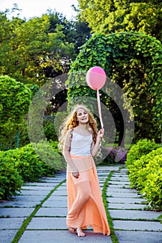 Beautiful girl with balloon have a fun in the park.