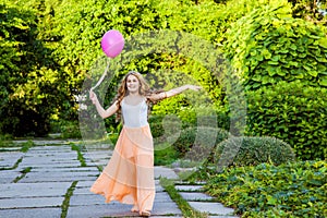 Beautiful girl with balloon have a fun in the park.