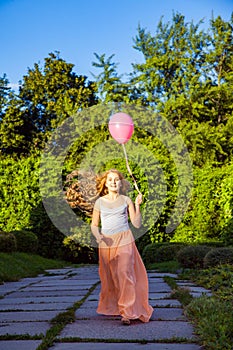 Beautiful girl with balloon have a fun in the park.