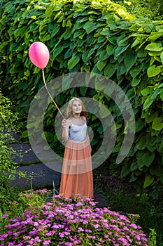 Beautiful girl with balloon have a fun in the park. photo
