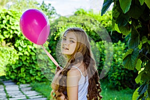 Beautiful girl with balloon have a fun in the park. photo