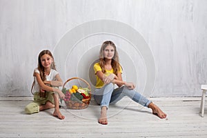 Beautiful girl with a basket of fresh vegetables, radishes, broccoli, tomato pepper