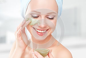 Beautiful girl in bathroom and mask for facial skin care