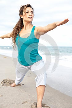 Beautiful girl at the beach doing yoga