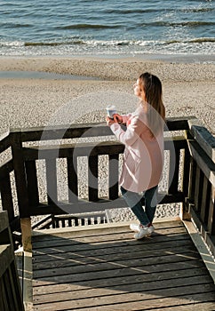 beautiful girl on the beach watching the sunset