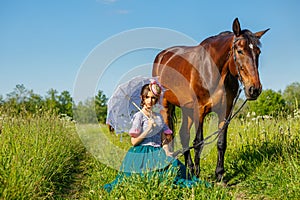 Beautiful girl in a beautiful dress standing next to the horse