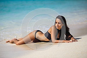 Beautiful girl in a bikini on the beach