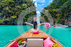 Beautiful girl in bikini on longtail boat at Koh hong island, Thailand photo