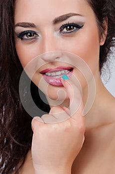 Beautiful girl is biting her finger attractively