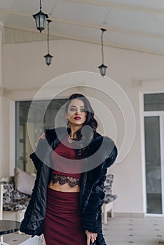 Beautiful girl in a black coat posing for the camera