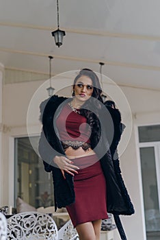 Beautiful girl in a black coat posing for the camera