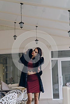 Beautiful girl in a black coat posing for the camera