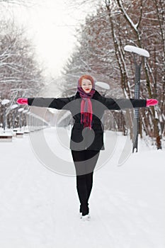 Beautiful girl in black goes with outstretched arms